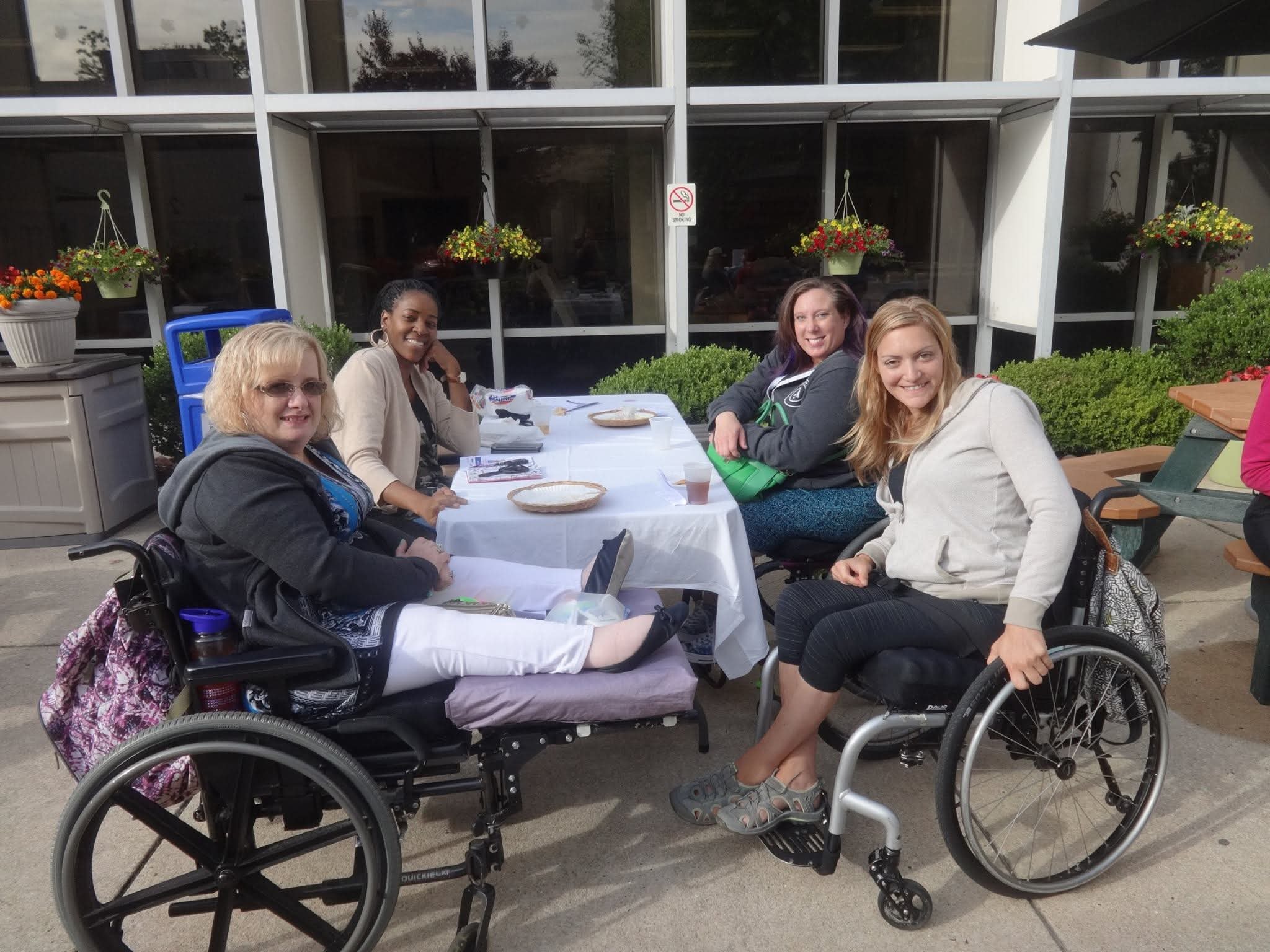 Four members at outdoor community luncheon