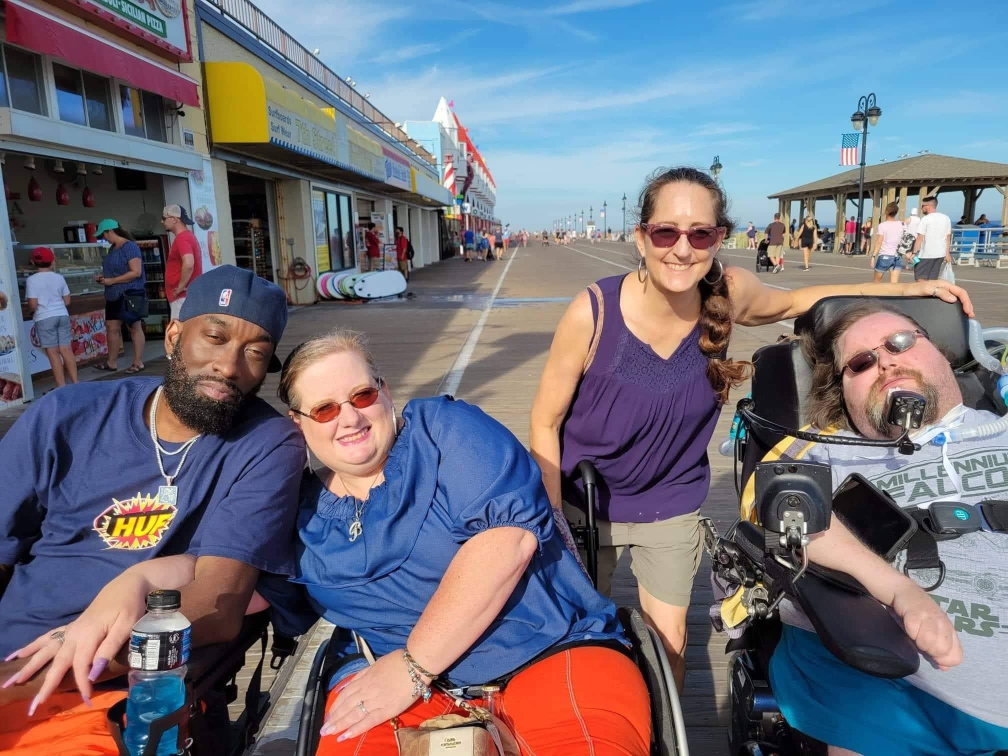Four members on the boardwalk — amusement park outing