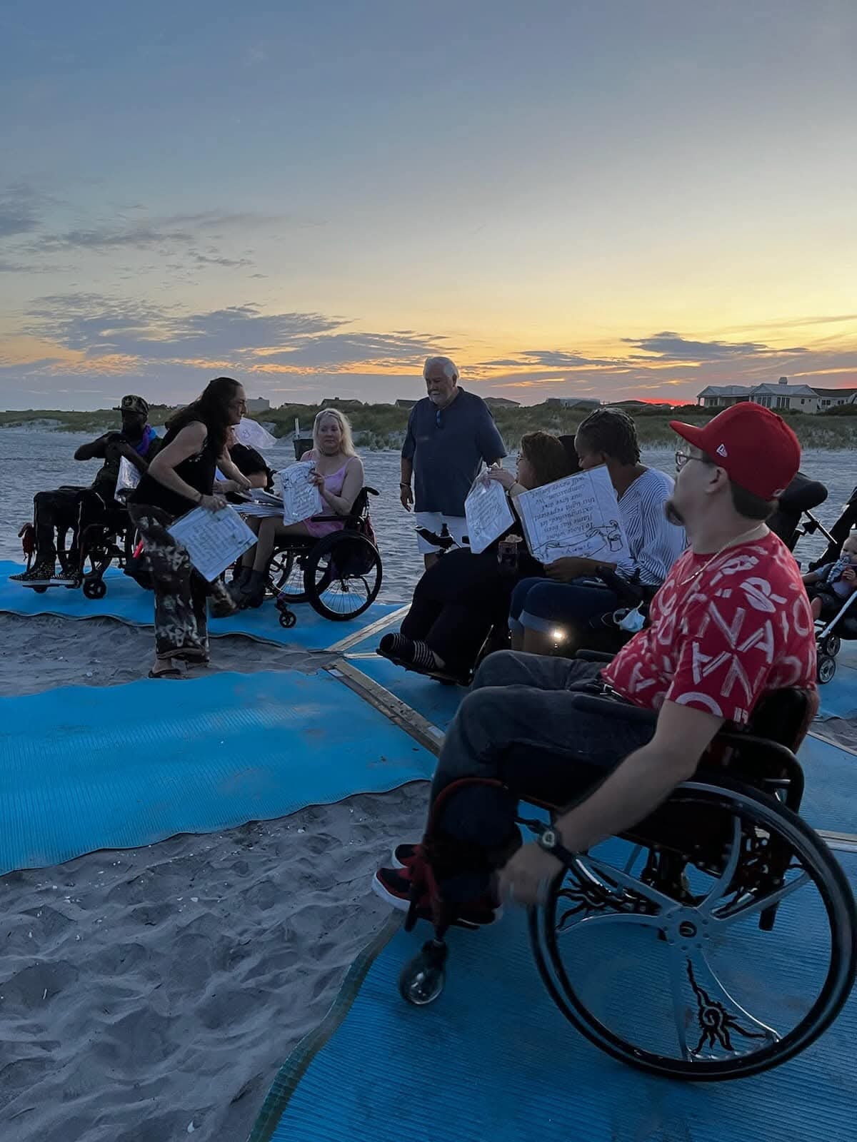 Community beach gathering at sunset